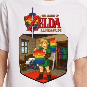 Un t-shirt représente Link de The Legend of Zelda tenant un t-shirt de la Triforce arc-en-ciel. Derrière lui se trouvent des épées, des boucliers et des costumes. Célébrant la fierté LGBTQIA+, le texte se lit comme suit : "The Legend of Zelda : A Link to the Pride" (La légende de Zelda : un lien vers la fierté).